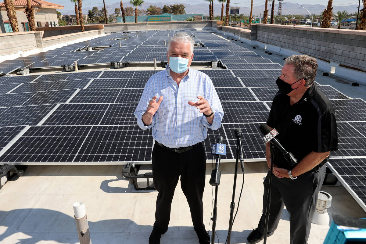 Nevada Gov. Steve Sisolak, left, and Catholic Charities of Southern Nevada CEO Deacon Tom Rober ...