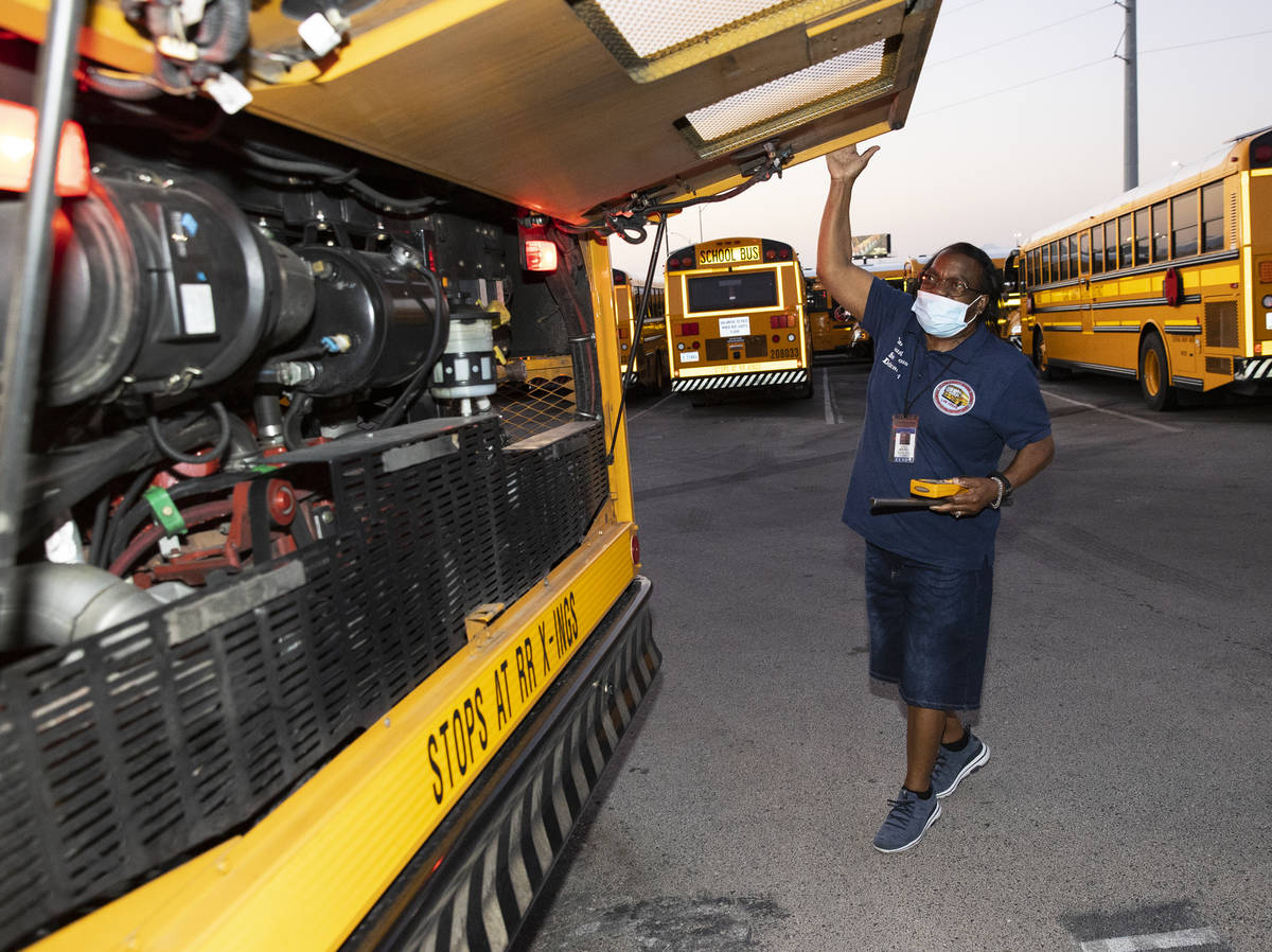 Patricia Wallace, a bus driver with the Clark County School District, inspects her bus at Arvil ...