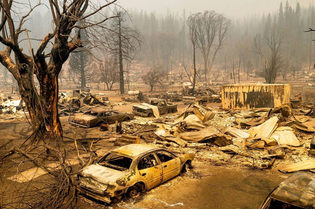 This photo shows cars and homes destroyed by the Dixie Fire line central Greenville on Thursday ...