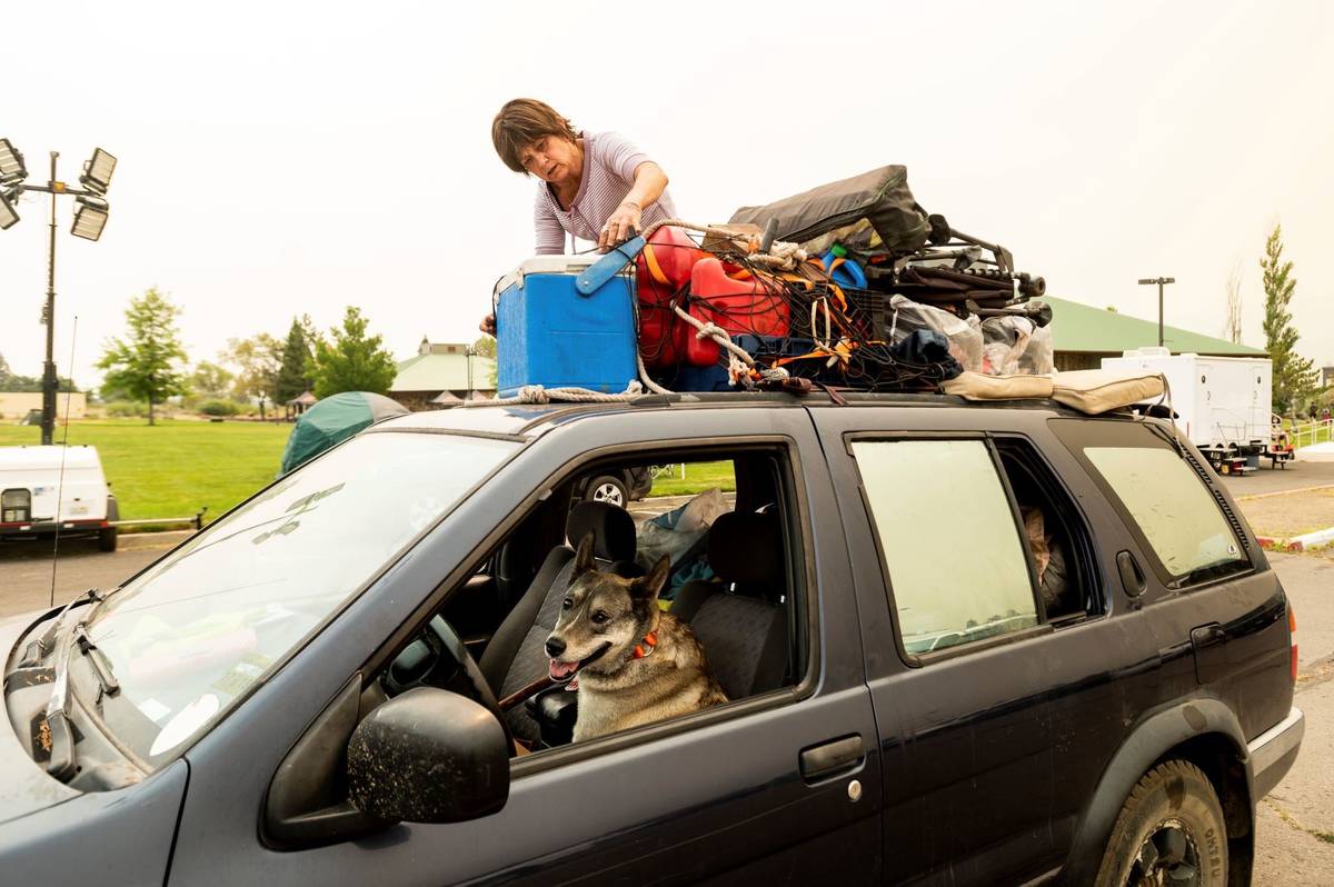 Greenville resident Kesia Studebaker, who lost her home to the Dixie Fire, secures belongings b ...