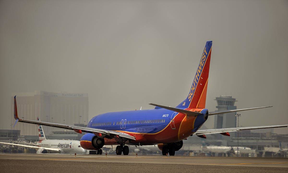 A Southwest Airlines plane prepares to take off as others move along the tarmac at McCarran Int ...