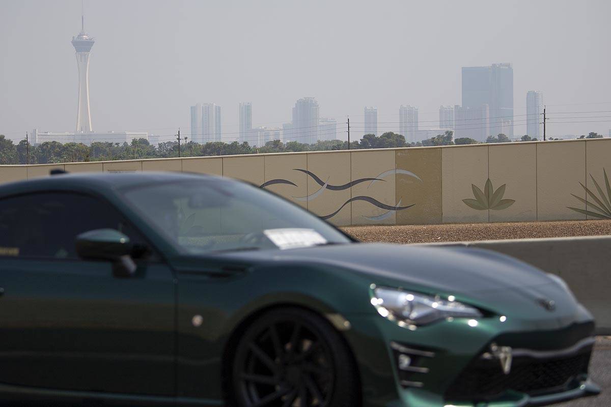 A motorist exits onto Valley View Drive from US 95 as smoky skies cloud the Las Vegas Strip sky ...