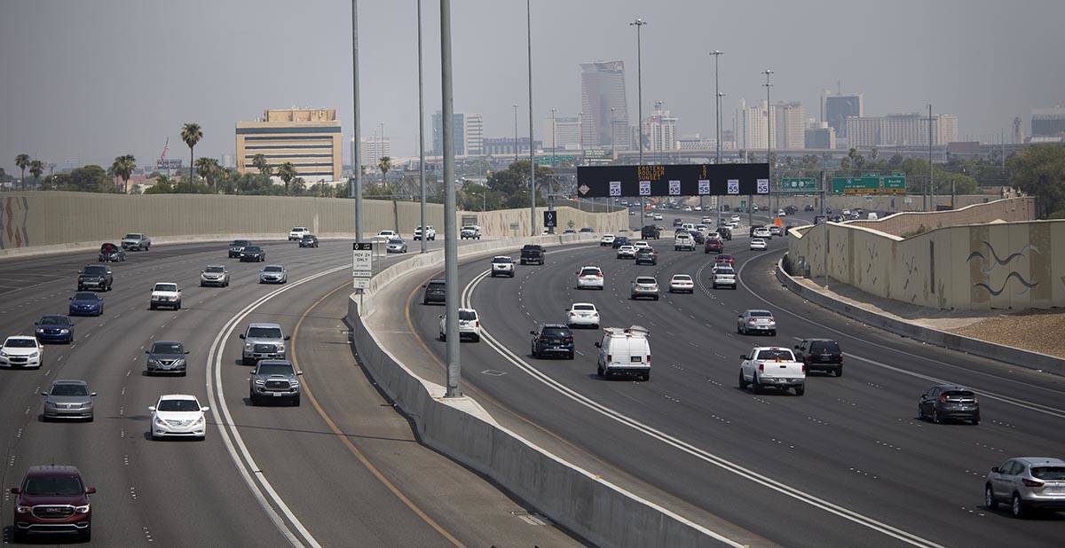 Traffic moves along US 95 while smoky skies cloud the downtown skyline on Saturday, Aug. 7, 202 ...
