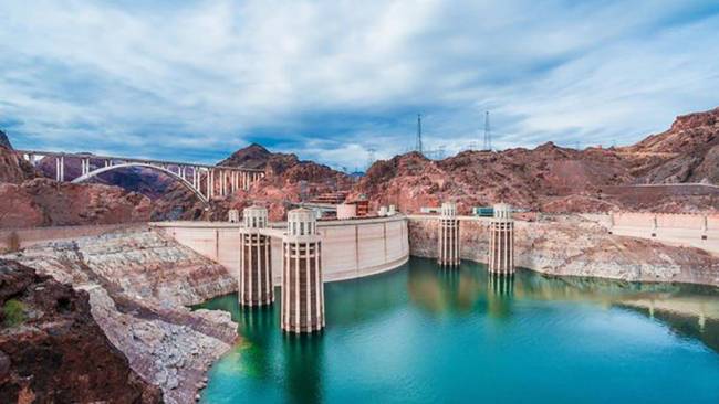 The Hoover Dam is situated on the Colorado River, on the border between Nevada and Arizona. The ...