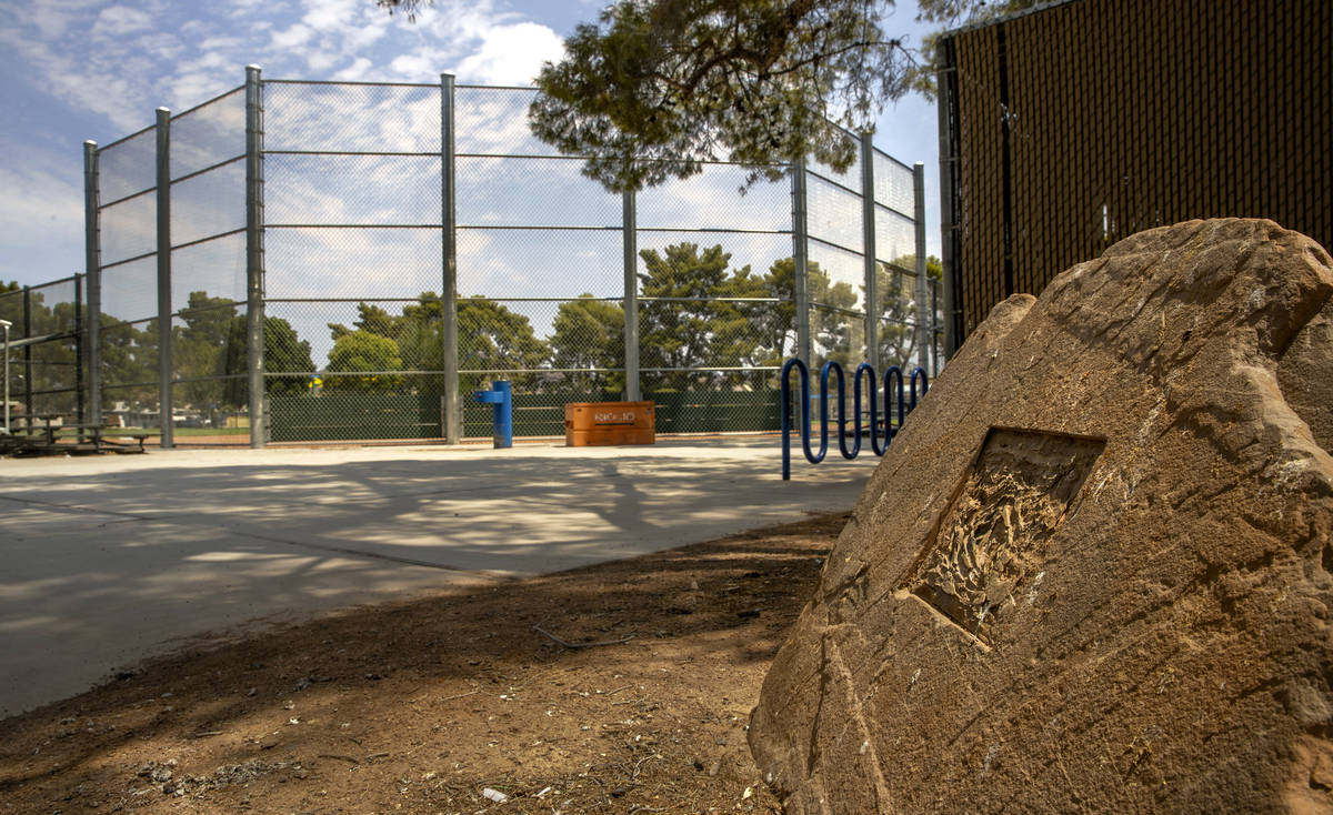 Rock with a missing plaque for Hector Perez who was fatally shot near the ball field at Maslow ...