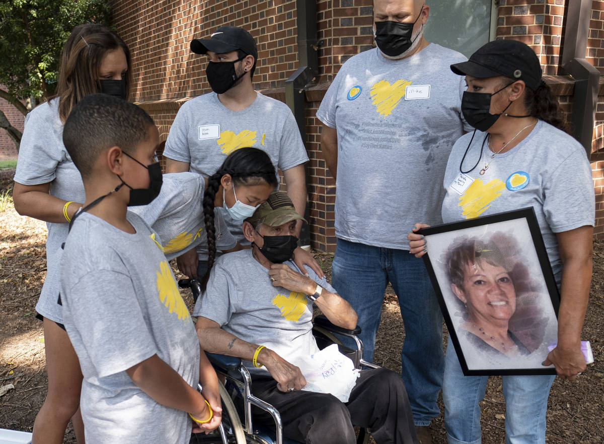 Louis Pabon, center, who lost his wife Miriam to COVID, attends a National COVID Awareness Day ...