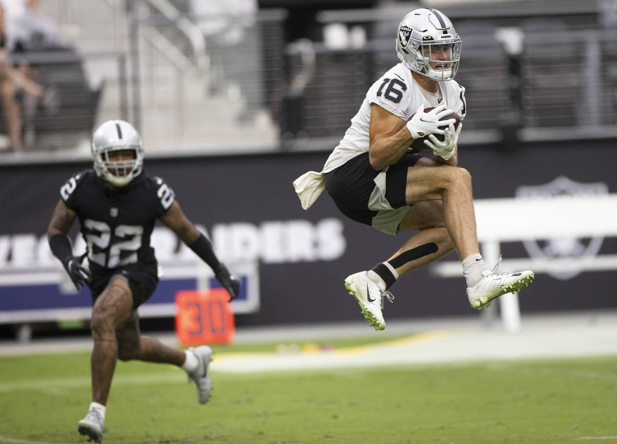 Raiders wide receiver Dillon Stoner (16) makes a leaping catch past Raiders defensive back Keis ...