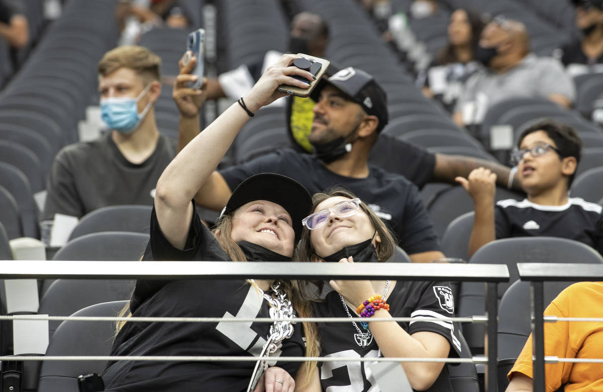 Raider fans take in the action during a special training camp practice for season ticket holder ...