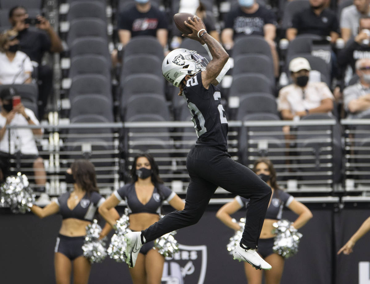 Raiders cornerback Damon Arnette (20) makes a leaping catch during a special training camp prac ...