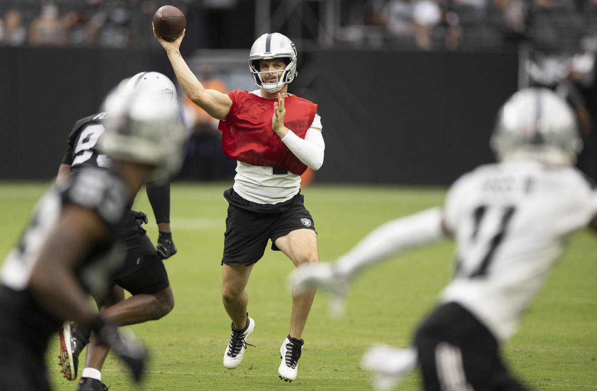 Raiders quarterback Derek Carr (4) makes a sideline throw to Raiders wide receiver Henry Ruggs ...