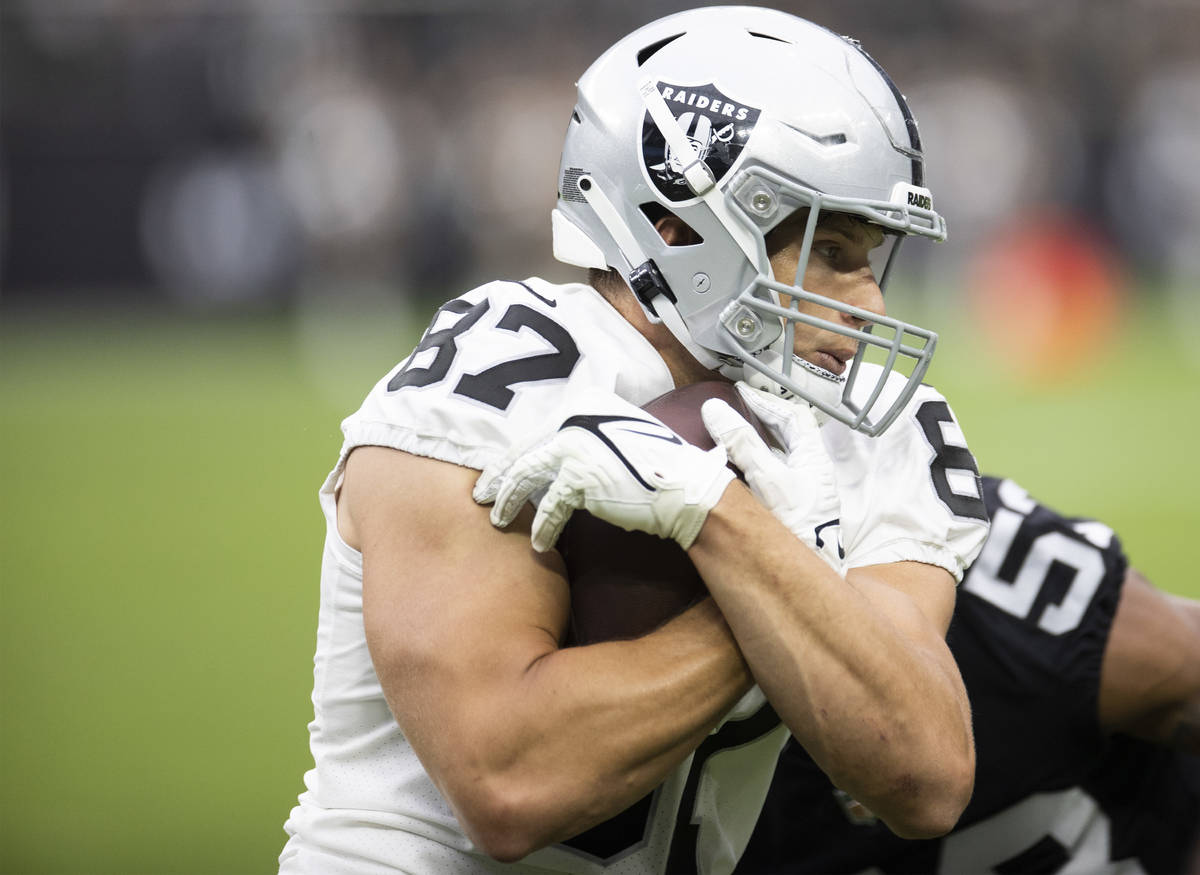 Raiders tight end Foster Moreau (87) is tackled by Raiders linebacker Javin White (53) during a ...