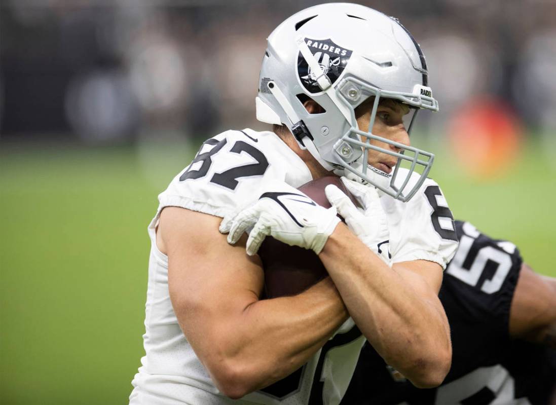 Raiders tight end Foster Moreau (87) is tackled by Raiders linebacker Javin White (53) during a ...