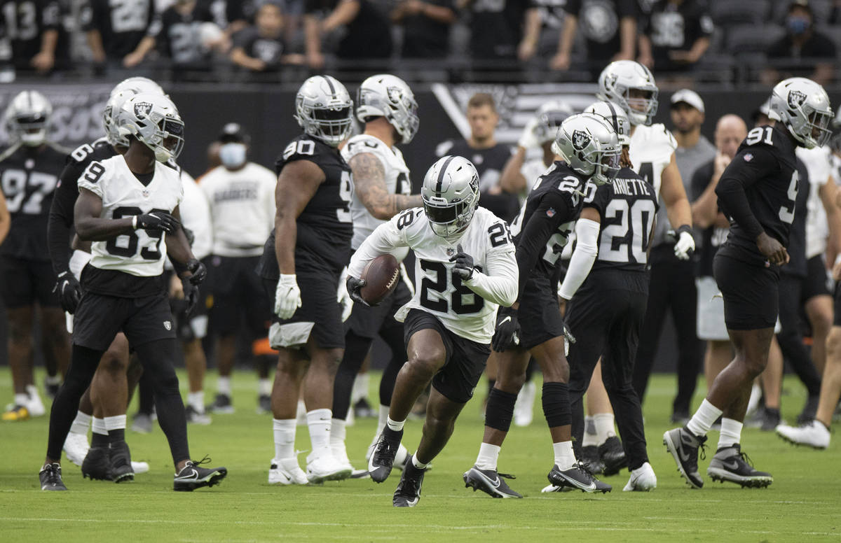 Raiders running back Josh Jacobs (28) breaks free for a big run during a special training camp ...