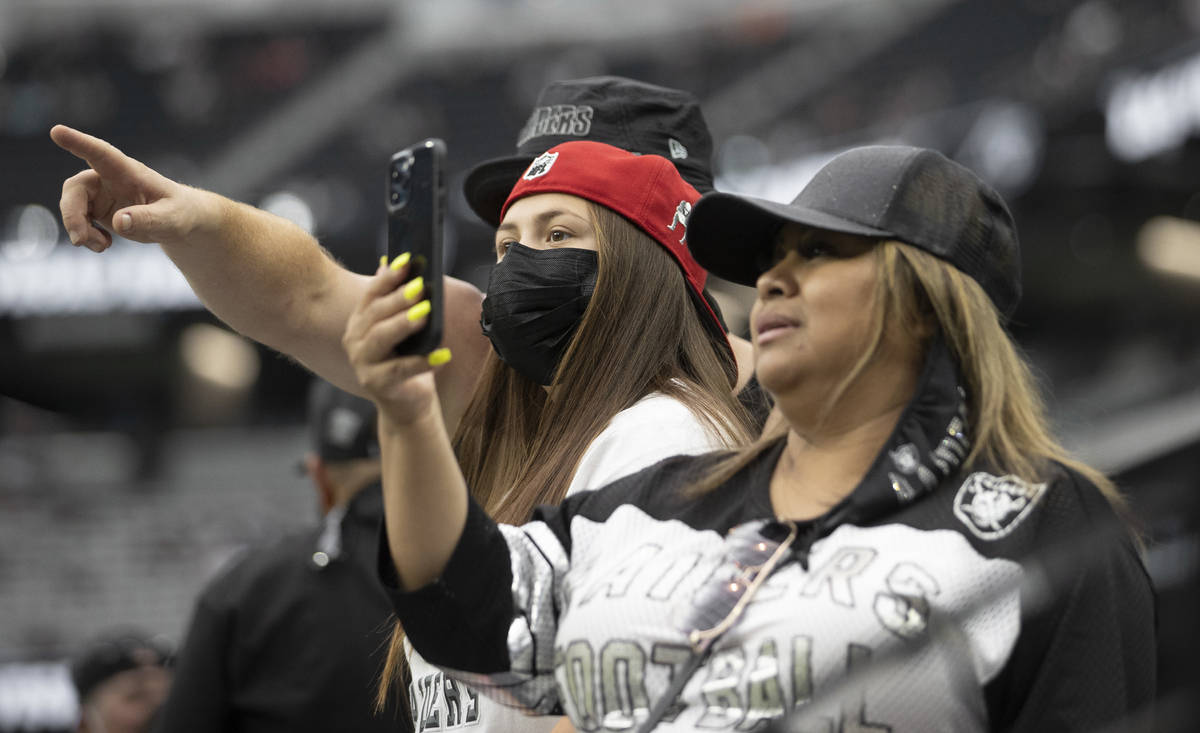 Raider fans take in the action during a special training camp practice for season ticket holder ...