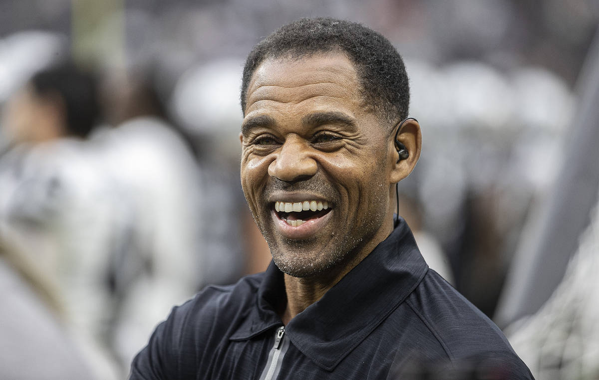 Former Raider player Eric Allen shares a laugh with staff on the sideline during a special trai ...