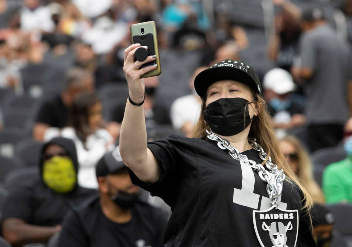 Raider fans take in the action during a special training camp practice for season ticket holder ...