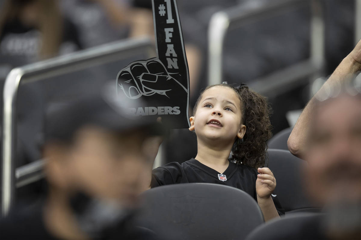 Raider fans take in the action during a special training camp practice for season ticket holder ...