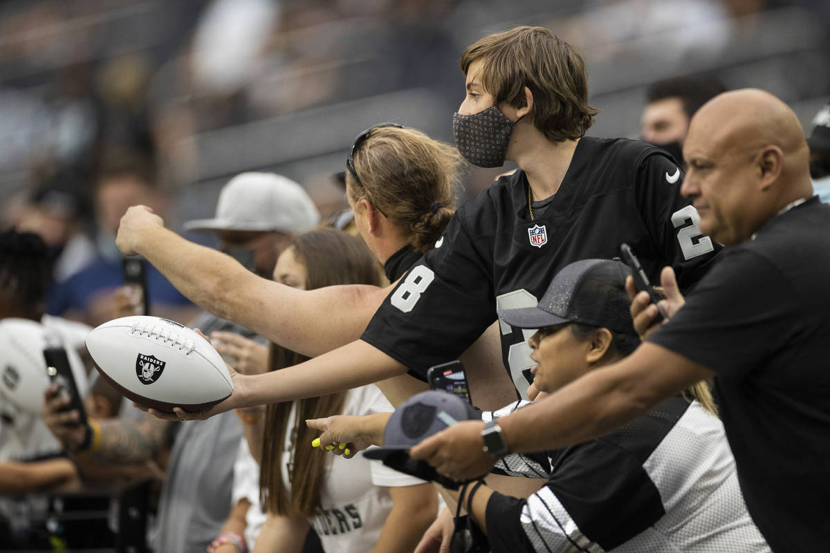 Raider fans take in the action during a special training camp practice for season ticket holder ...