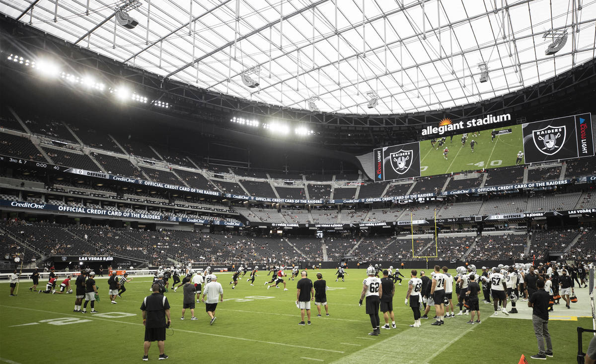 The Raiders scrimmage during a special training camp practice for season ticket holders, team e ...