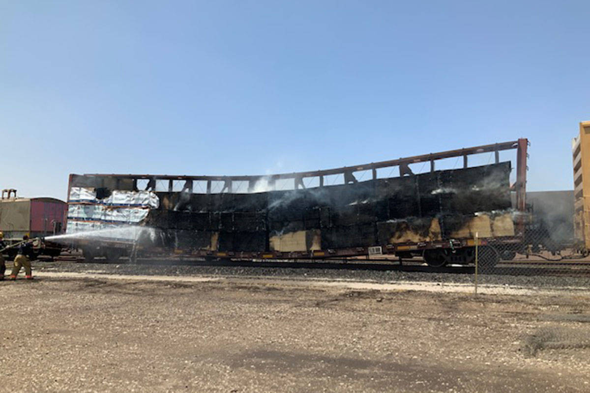 Crews battle a flatbed rail car Sunday, Aug. 8, 2021, at 926 S. Commerce St. in Las Vegas. (La ...