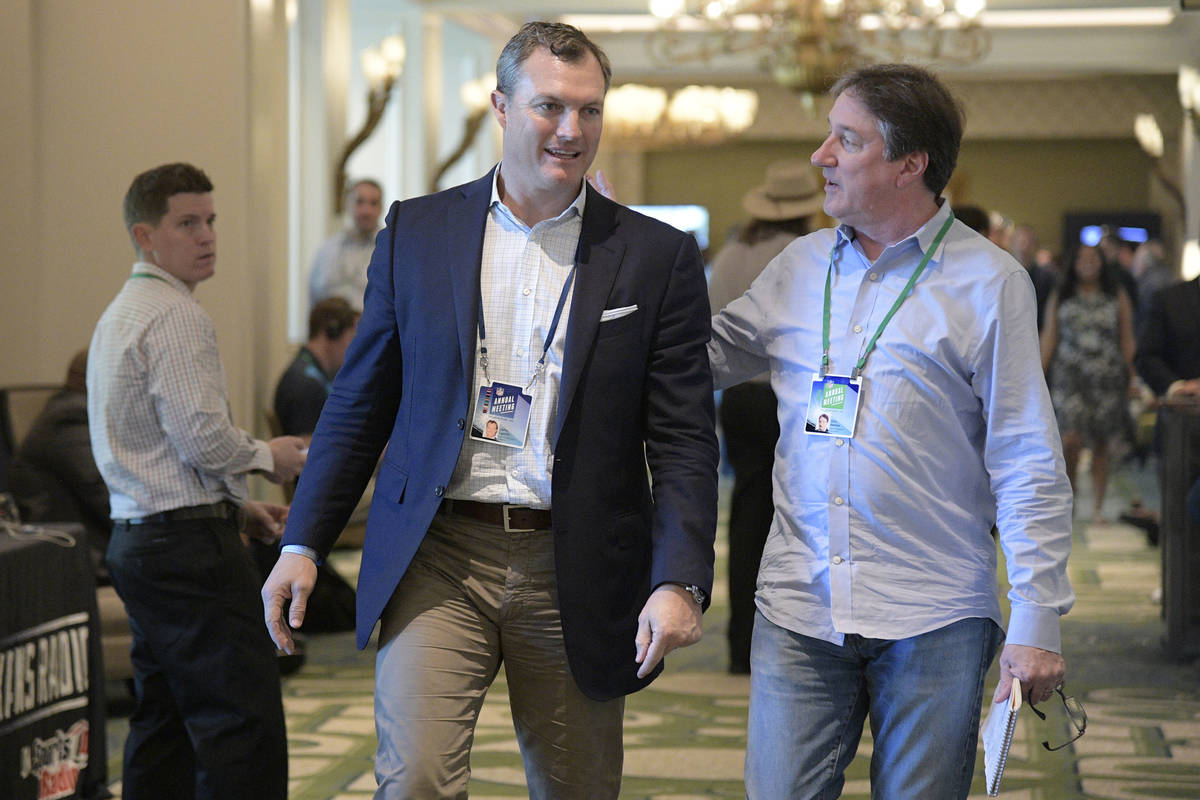 San Francisco 49ers general manager John Lynch chats with Don Banks, right, while walking to a ...