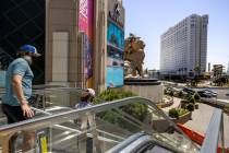 Pedestrians walk down stairs outside the MGM Grand across from the Tropicana on the Las Vegas S ...