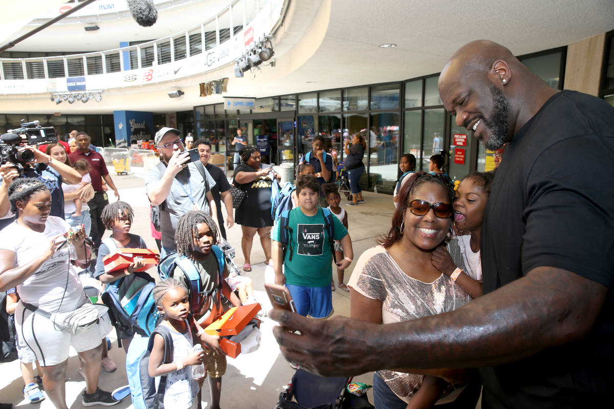 Terri Ware and her daughter Micah Ware Broady, 9, of Las Vegas pose with Shaquille O'Neal durin ...