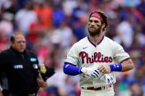 Philadelphia Phillies' Bryce Harper, right, is congratulated in the dugout by Alec Bohm after H ...