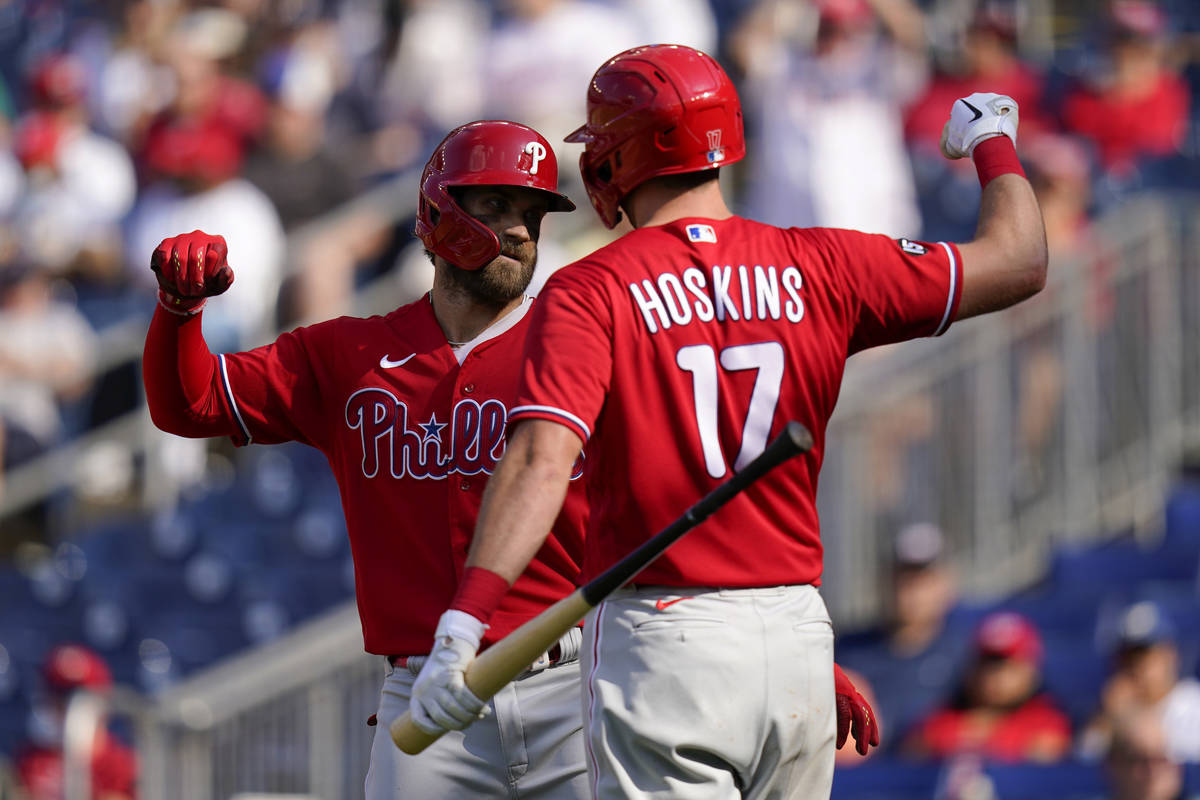 Philadelphia Phillies' Bryce Harper, left, celebrates with teammate Rhys  Hoskins after hitting …