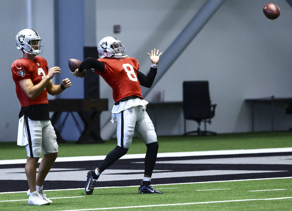 Raiders quarterback Marcus Mariota (8) looks to throw a pass alongside quarterback Nathan Peter ...