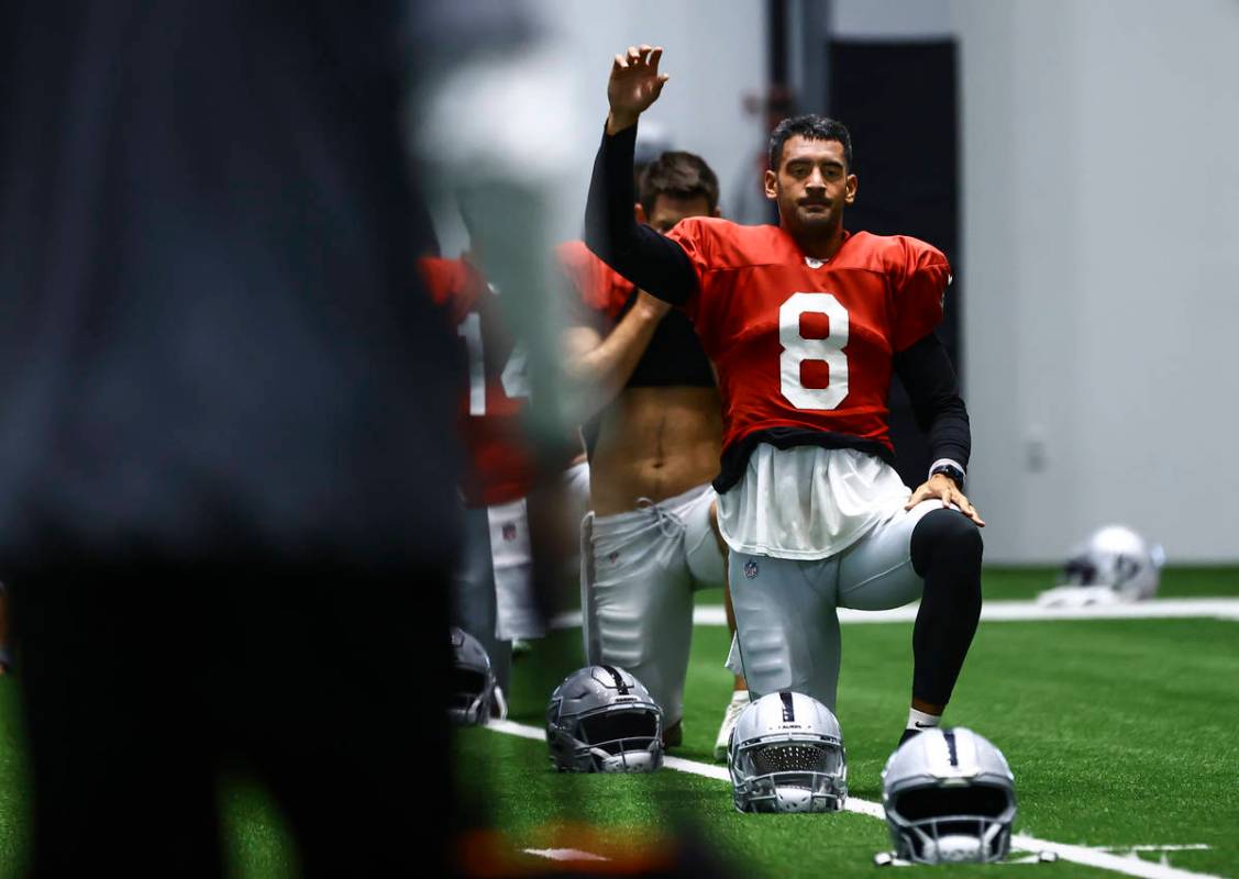 Raiders quarterback Marcus Mariota stretches during training camp at Raiders Headquarters/Inter ...