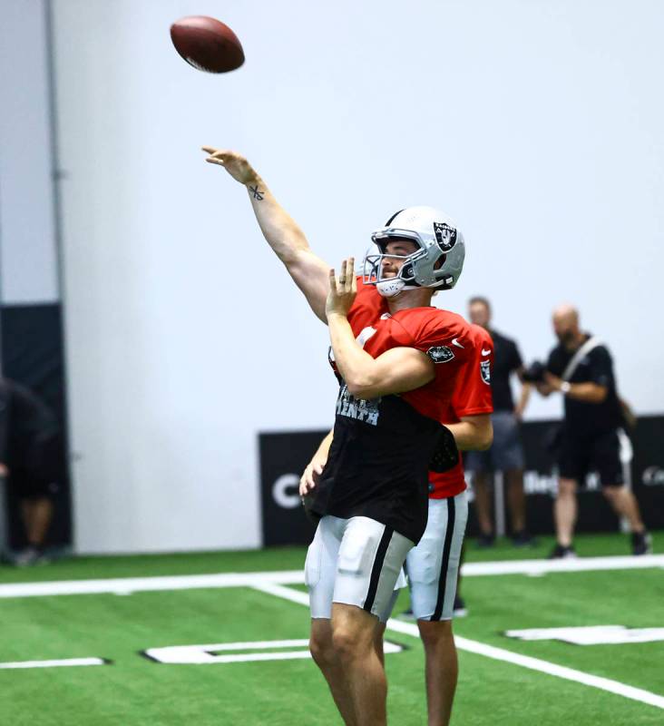 Raiders quarterback Derek Carr throws a pass during training camp at Raiders Headquarters/Inter ...