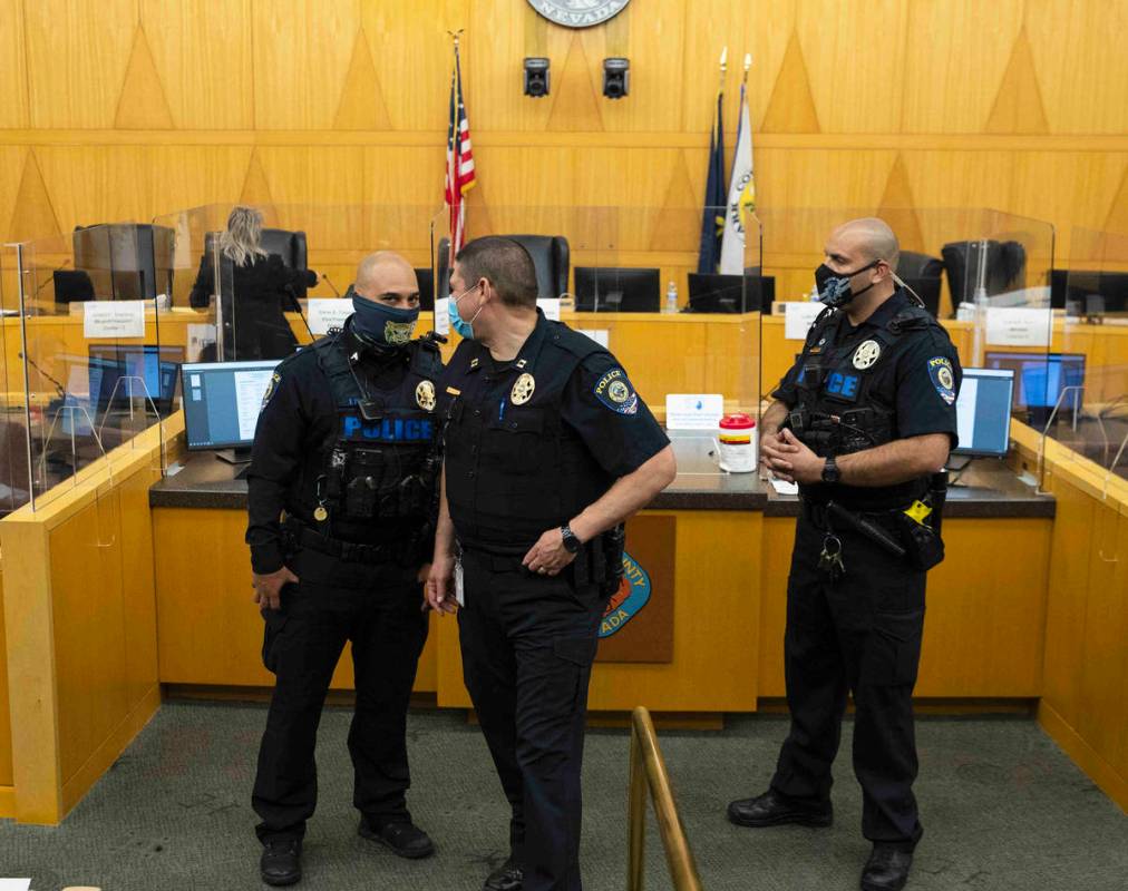 The Clark County School District police officers stand guard after protesters against a COVID-1 ...