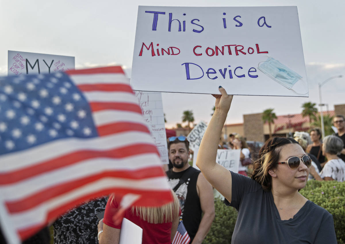 Protesters hold signs opposing the mask mandate for Clark County School District students on We ...