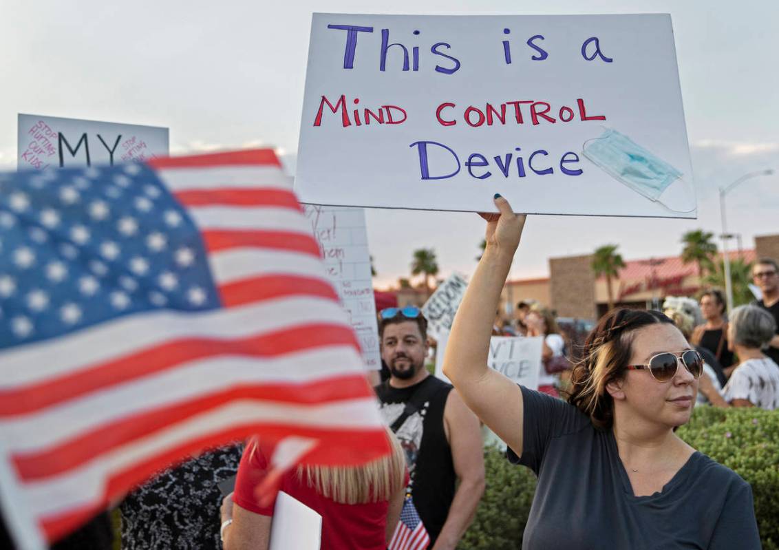 Protesters hold signs opposing the mask mandate for Clark County School District students on We ...