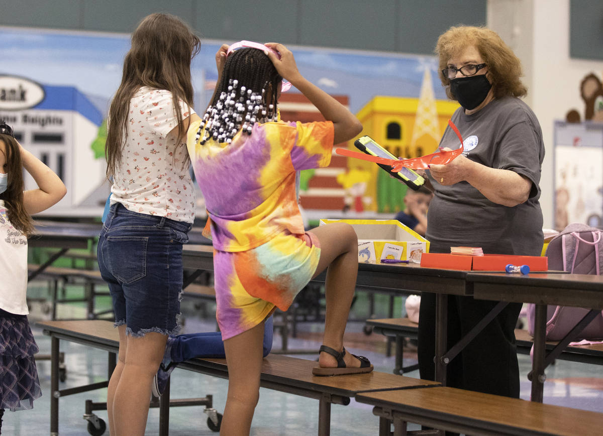Safekey site lead Marge Galioto, right, plays a game with children at Garehime Elementary Schoo ...
