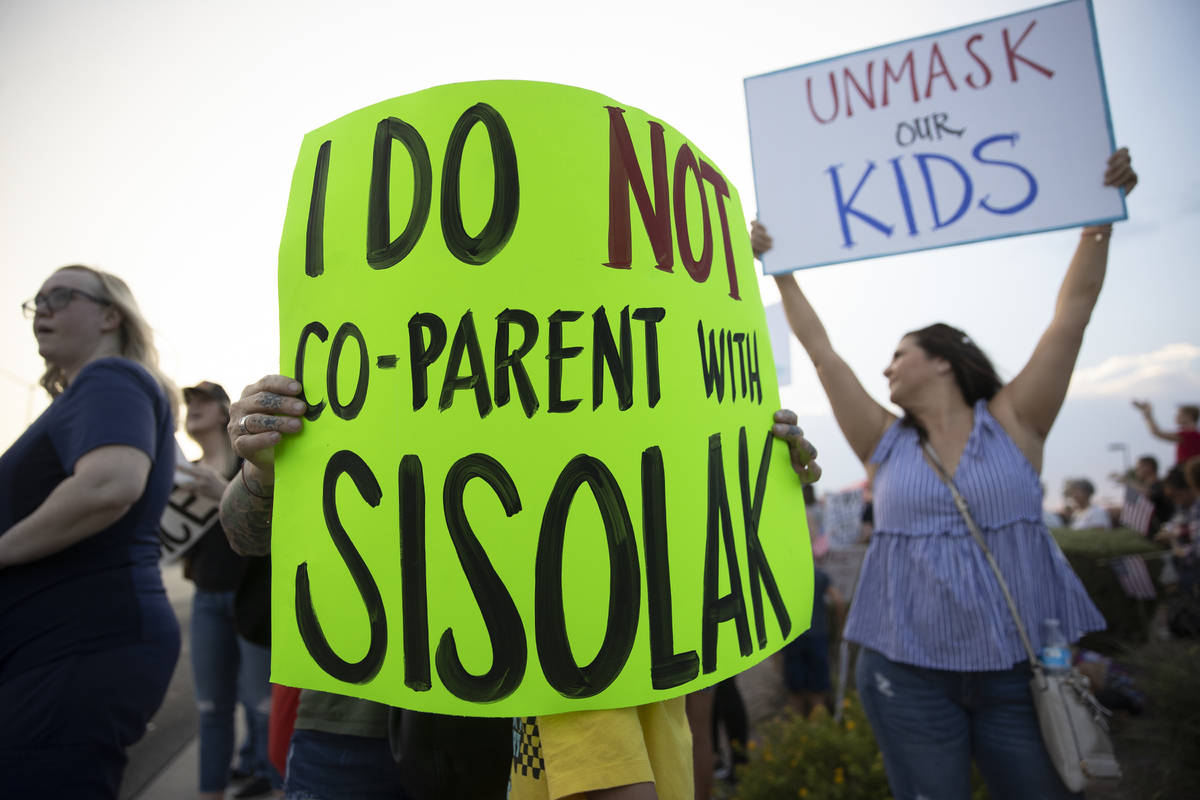 Protesters hold signs opposing the mask mandate for Clark County School District students on We ...