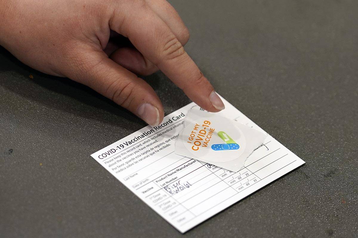 A COVID-19 vaccination card is displayed at the Banning Recreation Center in Wilmington, Calif. ...
