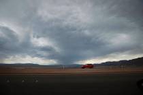A car drives on U.S. Route 93 around Boulder City, Wednesday, July 21, 2021, when dark clouds d ...