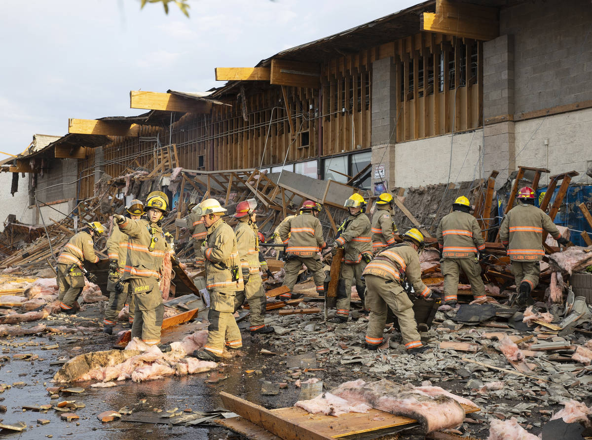 The Clark County firefighters work through debris after a portion of La Bonita supermarket coll ...
