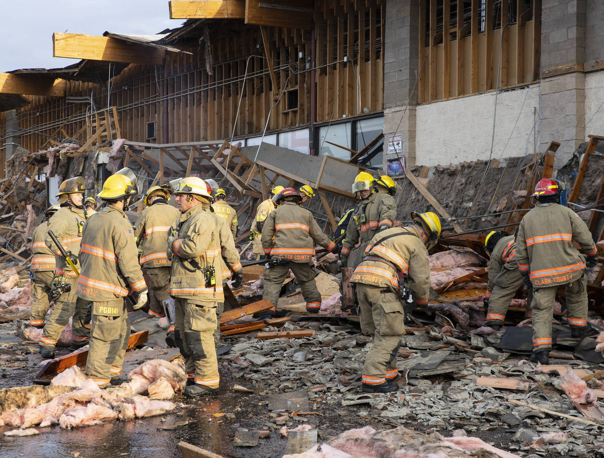 The Clark County firefighters work through debris after a portion of La Bonita supermarket coll ...