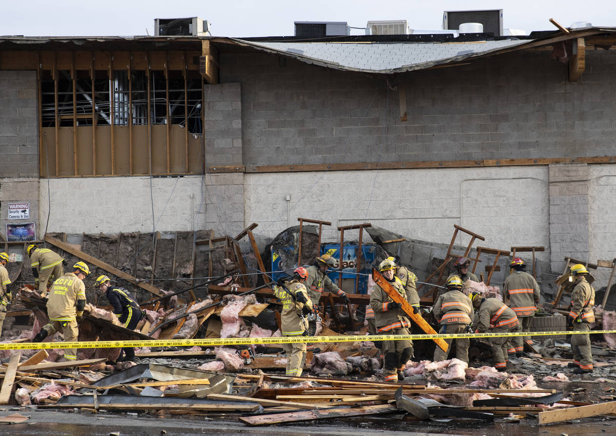 The Clark County firefighters work through debris after a portion of La Bonita supermarket coll ...