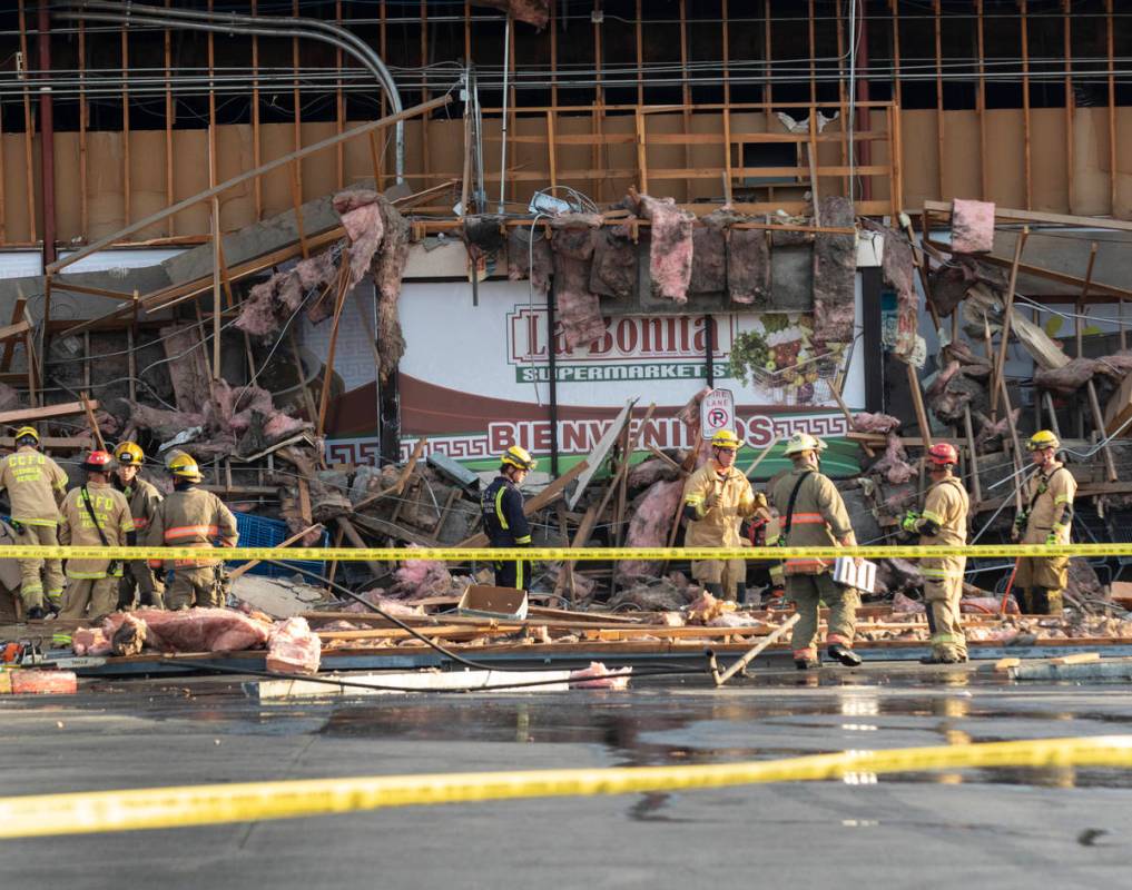 The Clark County firefighters work through debris after a portion of La Bonita supermarket coll ...