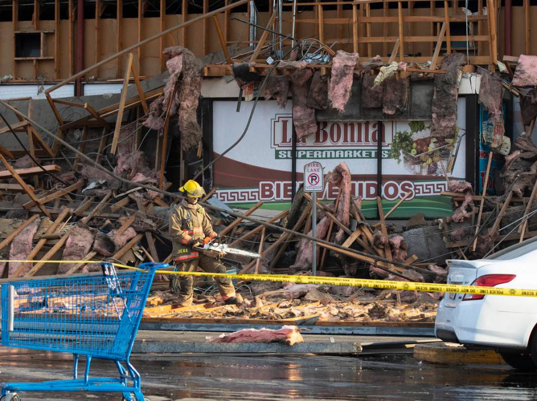 The Clark County firefighters work through debris after a portion of La Bonita supermarket coll ...