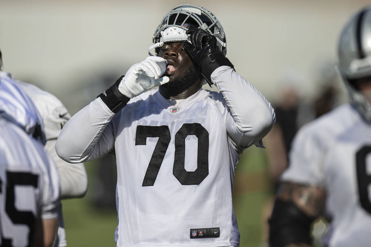 Raiders offensive tackle Alex Leatherwood (70) drinks water during training camp on Saturday, J ...