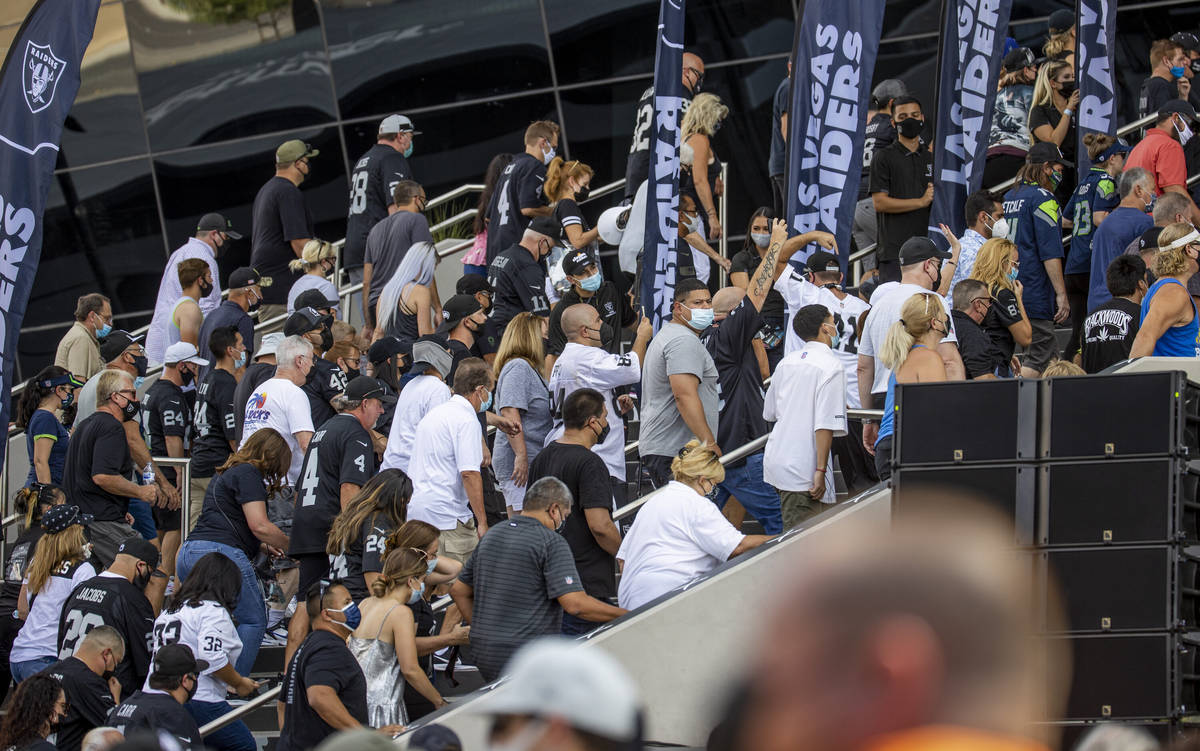 Fans climb the stairs to enter before the Raiders home opening pre-season NFL football game ver ...