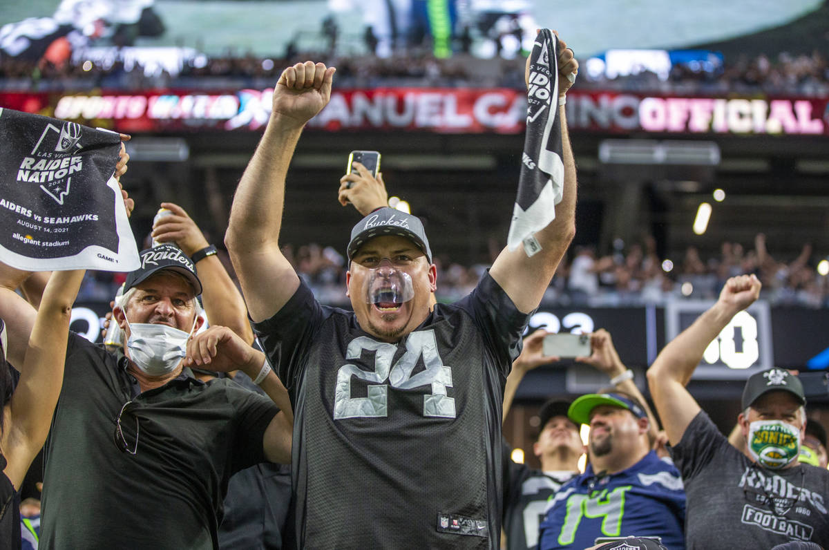 Raiders fans celebrate the first touchdown of the game during the first quarter of the Raiders ...