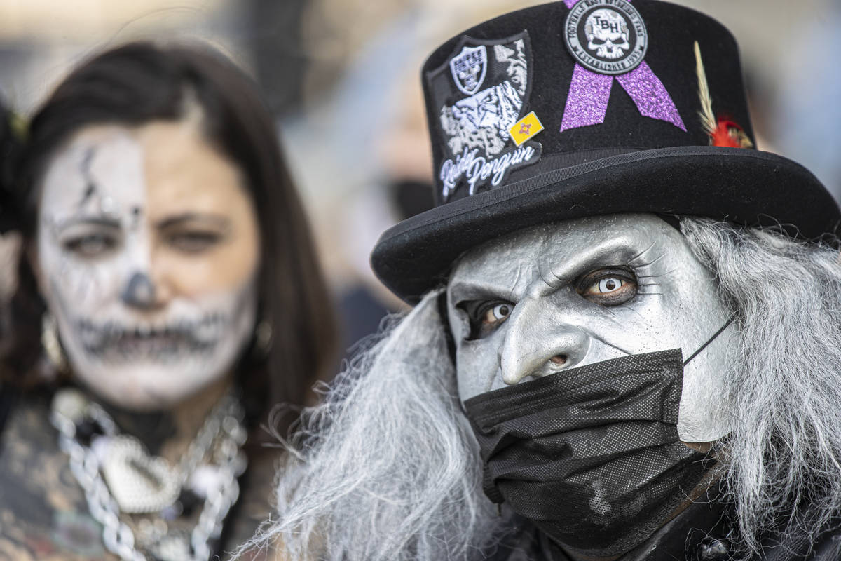 Las Vegas super fans Raider Penguin, right, and Darkness Rainz outside Allegiant Stadium before ...