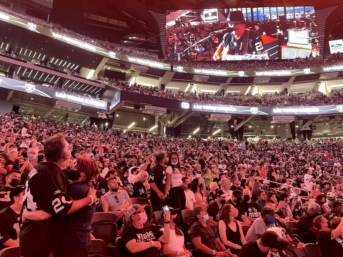 Carlos Santana, left, performs during halftime of the Raiders home opening pre-season NFL footb ...