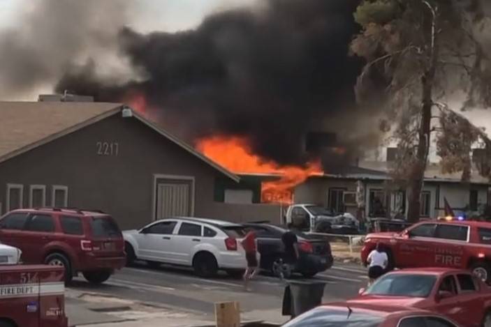 A fire engulfs a house in the 2200 block of North Bassler Street in North Las Vegas on Friday, ...